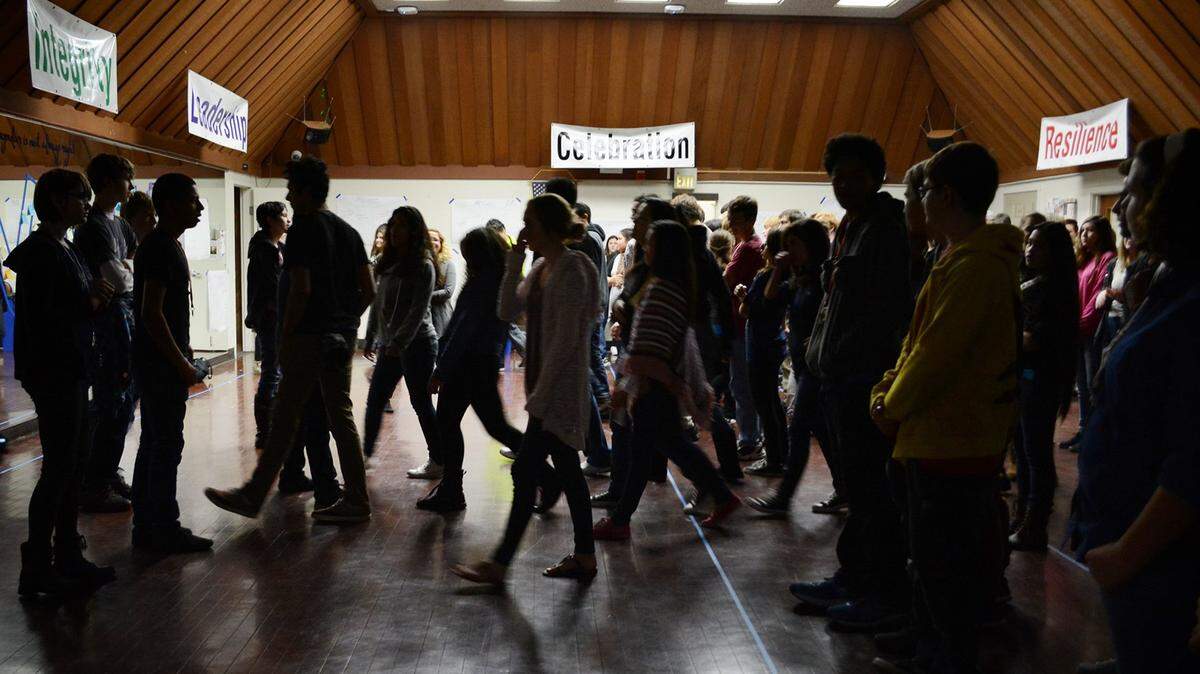 Students cross the line to identify as part of group with differences during an assembly at Valley Charter High School in Modesto, Calif., on Dec. 4., 2015.