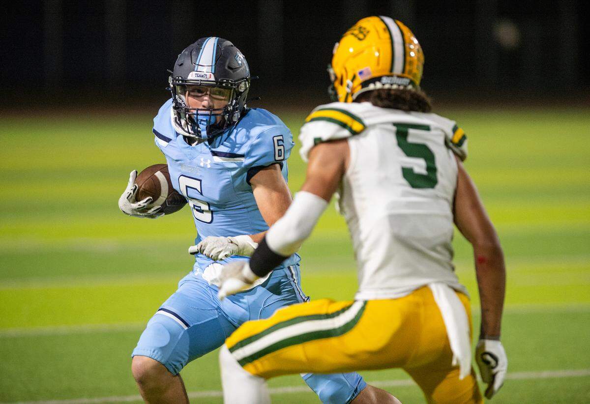 Downey’s Gavin Garcia runs the ball after a catch during the nonleague game with Tracy at Downey High School in Modesto, Calif., on Friday, September 16, 2022.