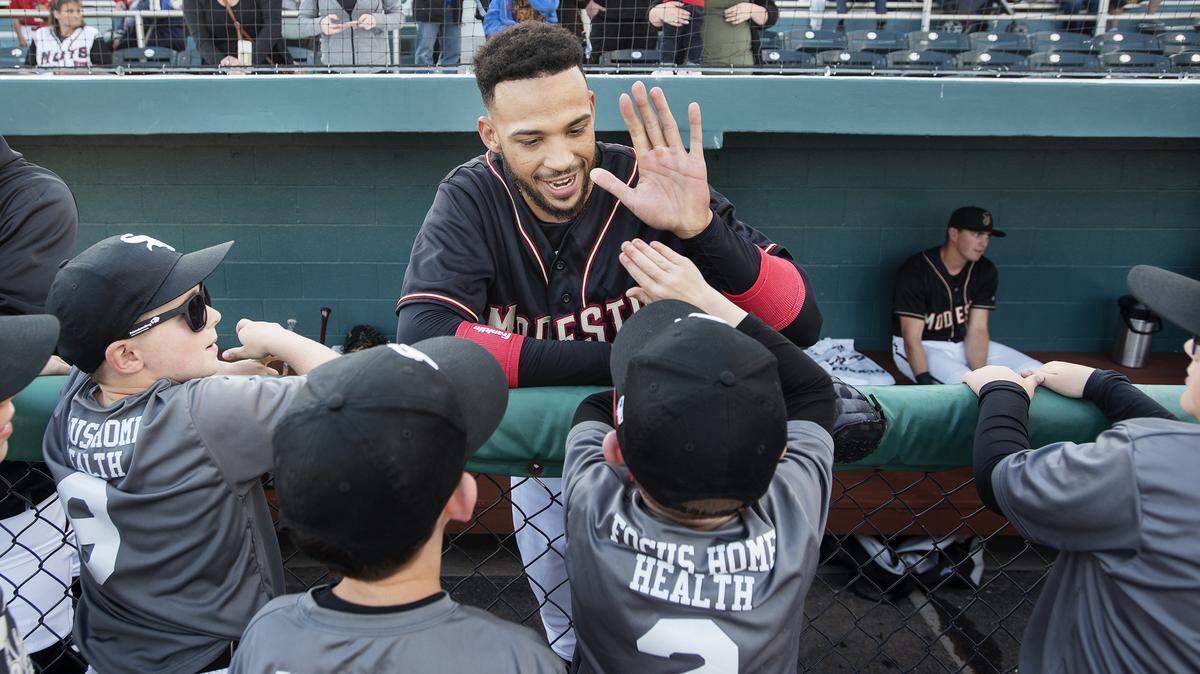 Modesto Nuts player Luis Liberato talks with Escalon Little League players before the opening day game with the Stockton Ports at John Thurman Field in Modesto, Calif., Thursday, April 11, 2019.