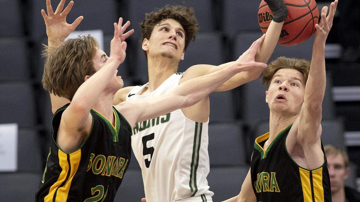 Sonora’s Jonathan Mayben, left, and Logan Sewell, right, battle for a rebound with Liberty Ranch defender Jayden Baroni during the Sac-Joaquin Section Division IV boys basketball championship game at the Golden 1 Center in Sacramento, Calif., Friday, Feb. 22, 2019. Sonora won the title 73-70.
