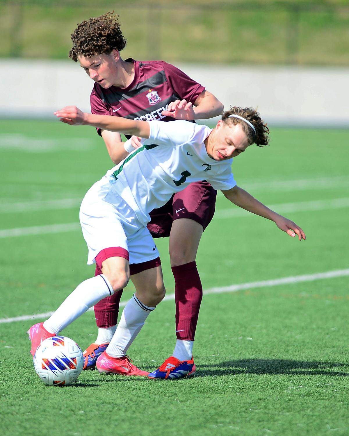 Pitman’s Zach Looney (2) fights for the ball against a Woodcreek defender during the Sac-Joaquin Section Division II championship against Woodcreek High School at Cosumnes River College in Sacramento, Calif. on Saturday, March 1, 2025.