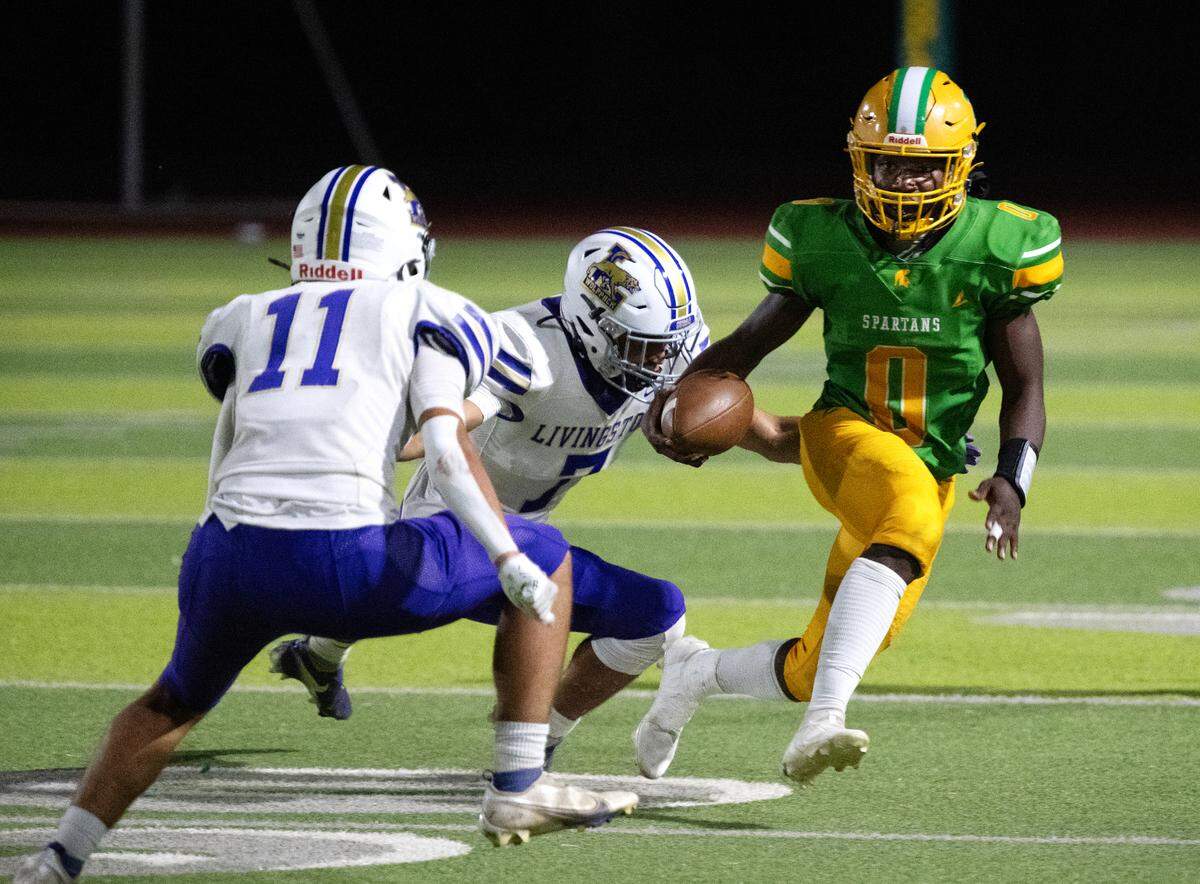 Davis’ Johan Chaney runs the ball during the Western Athletic Conference game with Livingston at Downey High School in Modesto, Calif., Thursday, Oct. 3, 2024. Davis won the game 14-10.