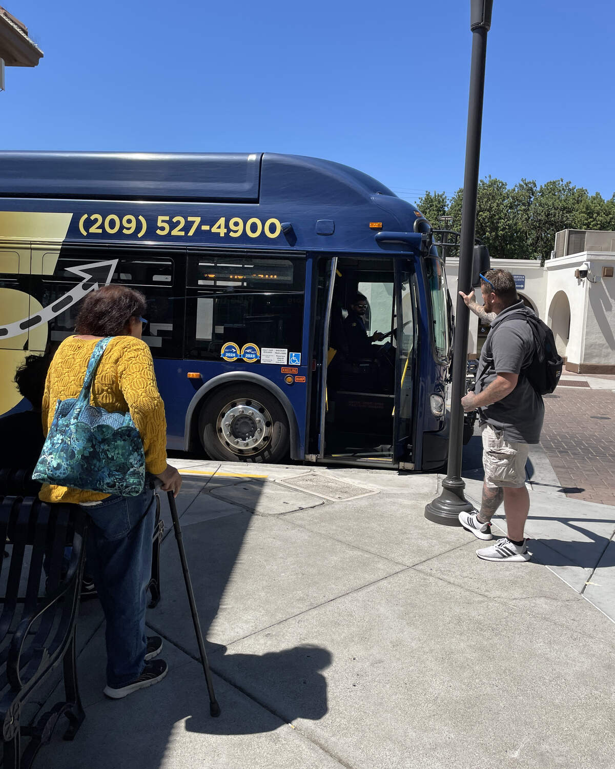Riders prepare to ride the bus at the Modesto Transit Center in Modesto, Wednesday, July 23, 2025.