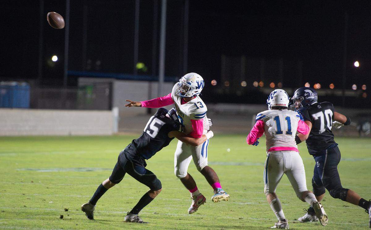Stone Ridge Christian junior outside linebacker Ethan Beene delivers a hit on Waterford quarterback Damien Tellez as he releases a pass during the Knights’ 48-16 homecoming win Friday night in Merced.