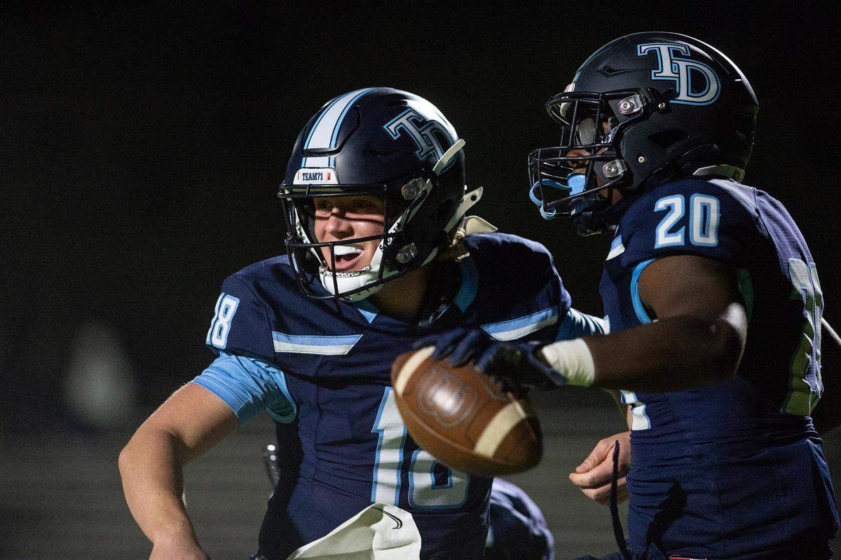 Downey’s Ki Ragland, right, and Conner Stoddard celebrate a touchdown during the Central California Athletic League game with Pitman at Downey High School in Modesto, Calif., Friday, Oct. 28, 2022.