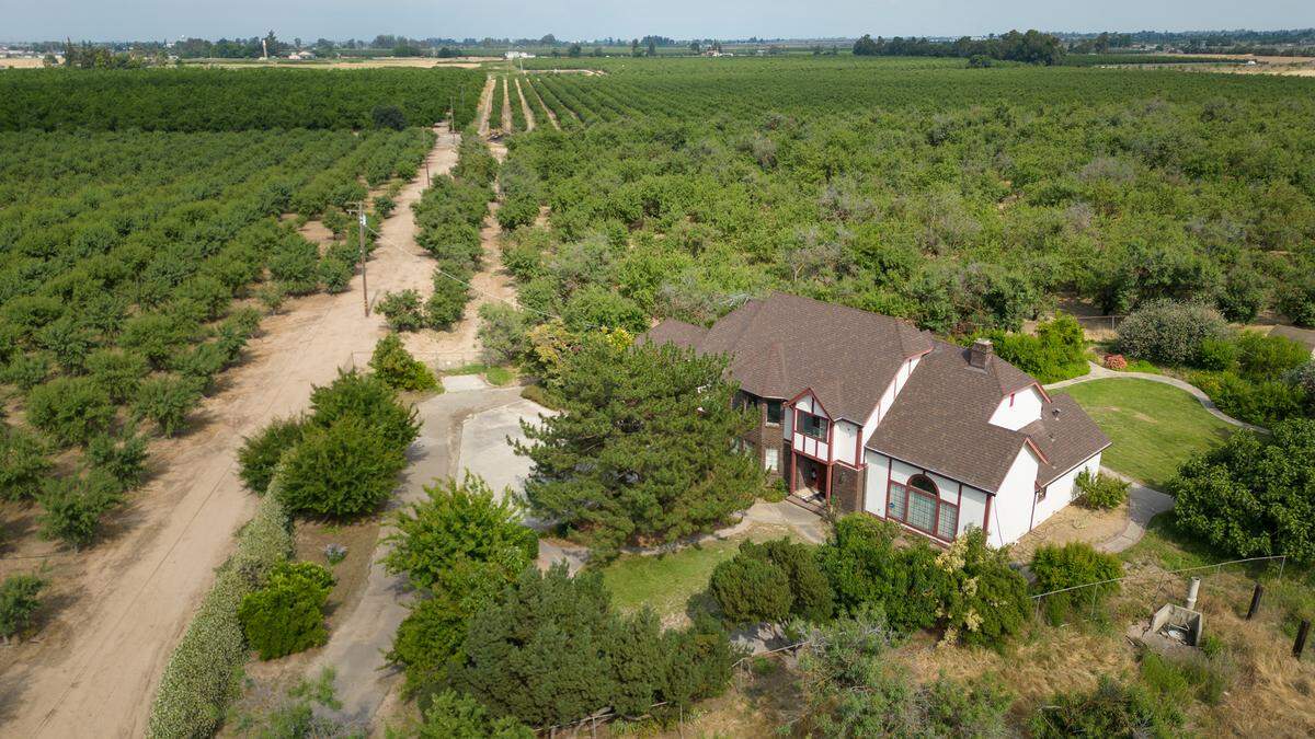 The home of Wolfgang and Victorina Bach looking east toward Roselle Ave from Oakdale Road in Modesto, Calif., Wednesday, June 7, 2023. Stanislaus County officials voted to exercise eminent domain powers to acquire property for the North County Corridor expressway, including the 23-acre Bach property. County Public Works says part of the flag-shaped parcel is needed for building the east-west four-lane route on a new alignment parallel with Claribel. The 3-mile section will connect with Claus Road.
