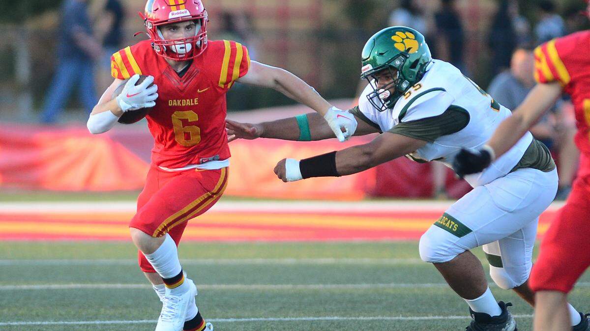 Oakdale running back Chase Lopez sprints away from a defender during a game between Oakdale High School and Sonora High School at Oakdale High School in Oakdale California CA on August 18, 2023.