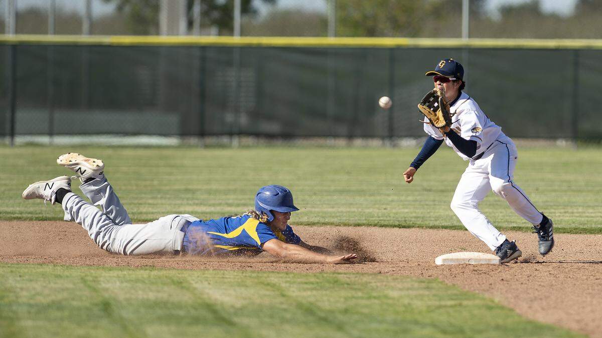 Turlock’s Garret Fountain beats the pick-off tag from Gregori’s Geno Reynosa during the Central California Athletic League game at Gregori High School in Salida, Calif., Wednesday, April 17, 2019.