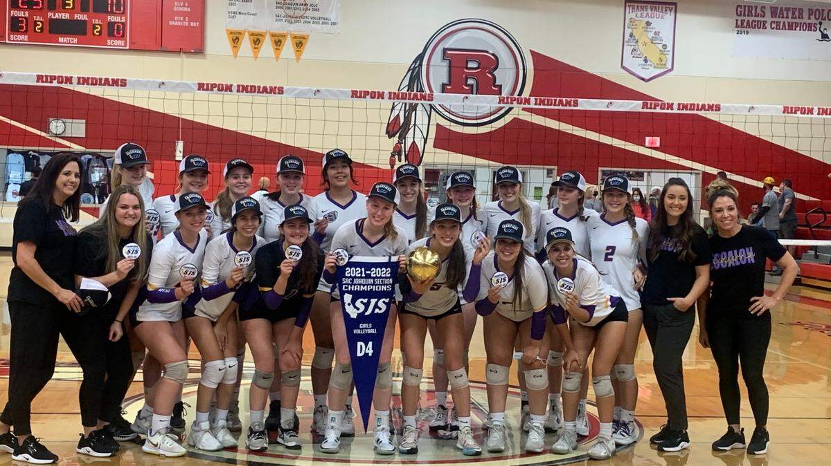 Escalon coaches and players take a photo after winning the CIF Sac-Joaquin Section Division IV Volleyball Championship final