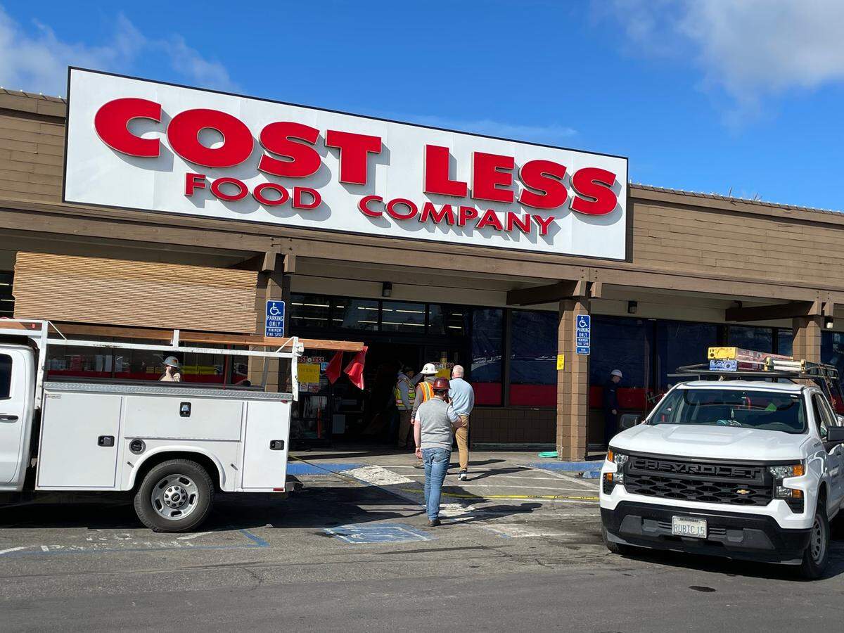 Construction crews at Cost Less Food Company in Oakdale after a part of the roof collapsed during a heavy storm on March 17.