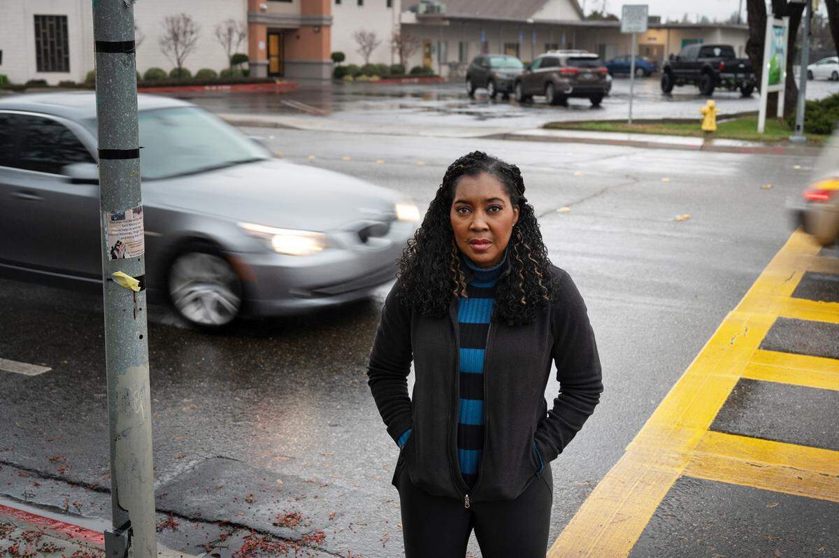 Ticka Simon-Rossetto stands across the street from where Modesto police say a hit-and-run driver struck and killed her brother William Simon on Orangeburg at Nelson Avenue about 7:15 p.m. Dec. 2. Simon was the 19th person to die in a Modesto traffic accident in 2022. Photographed in Modesto, Calif., Wednesday, Dec. 28, 2022.