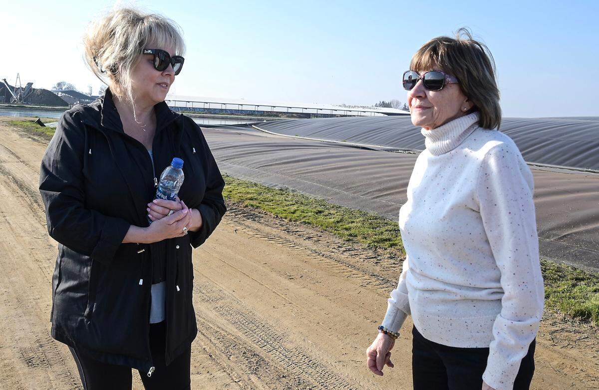 California Agriculture Secretary Karen Ross, right, talks with dairy farmer Debbie Ackerman.