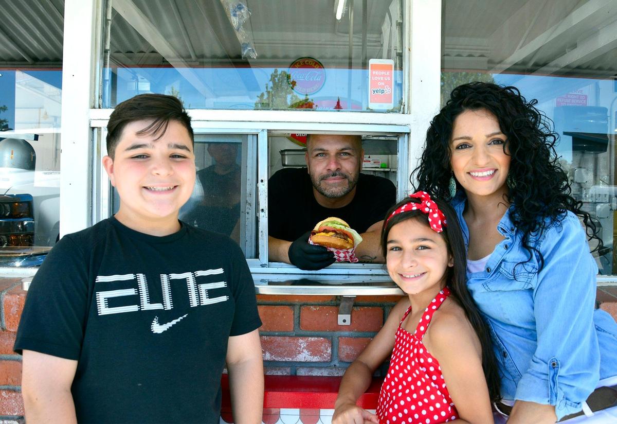 The owners of the Scenic Drive in in Modesto, Calif. pose at the burger stand with their children on Thursday June 6, 2019. Pictured L-R: Andrew, Matthew, Aubry, Ramcena Gregorian.