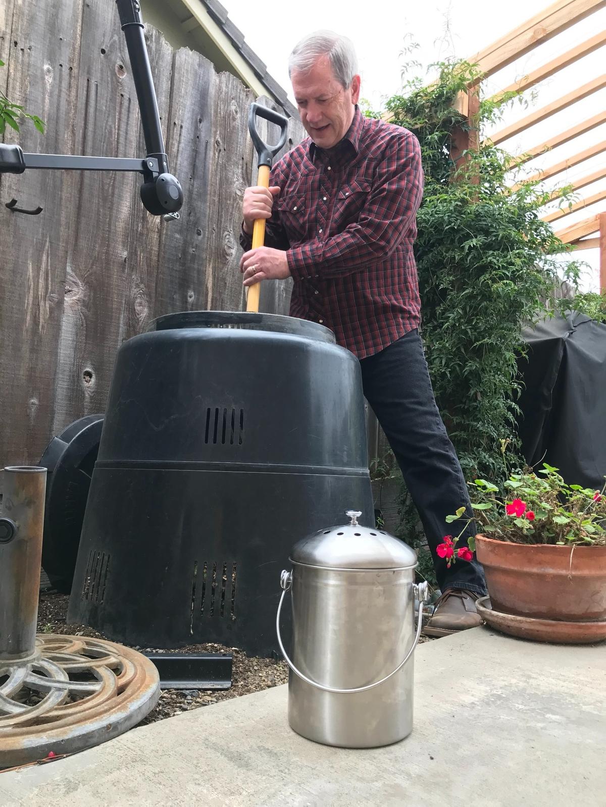 Modesto Bee opinions editor Garth Stapley stirs the backyard compost bin he received from Modesto City Hall eight years ago. The container he uses to transfer food scraps from his kitchen is in the foreground.