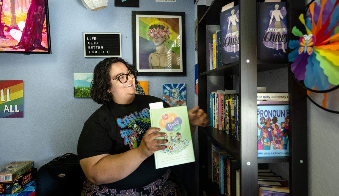 MoPride community organizer Veronica Ambrose shows the young adult book collection at the Central Valley Pride Center in Modesto, Calif., Thursday, Oct. 19, 2023.