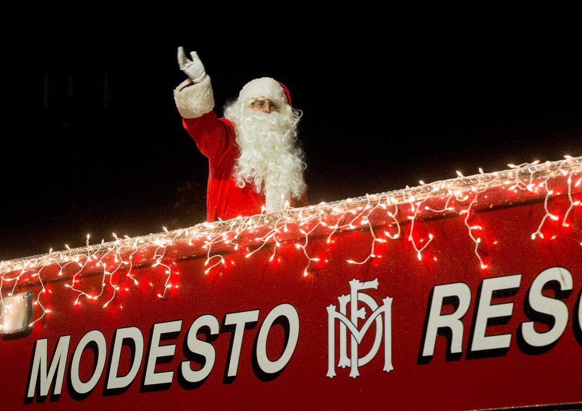 Santa Claus was on hand a top Modesto Fire Rescue 1 during the Celebration of Lights Parade in downtown Modesto Saturday, Dec. 1, 2018. 