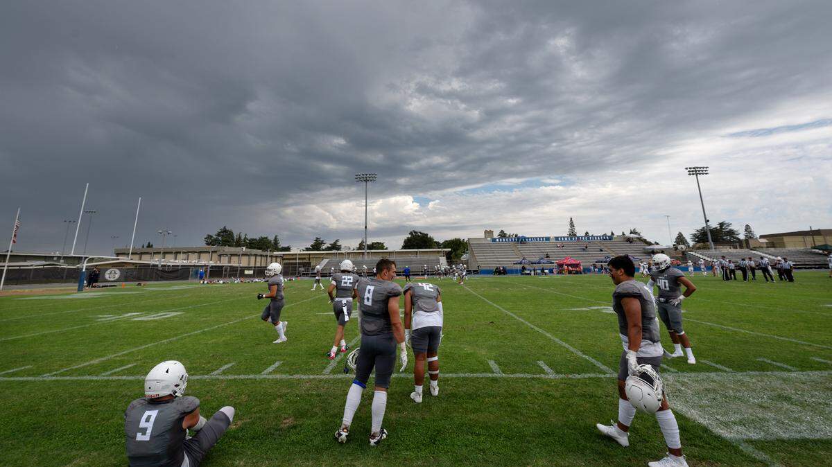Modesto players return to the field and warm up after the team’s home opener was stopped for 45 minutes in the second quarter due to lightning strikes near Modesto Junior College in Modesto, Calif., Saturday, September 9, 2023. Modesto went on to win the game 51-41 over Santa Rosa.