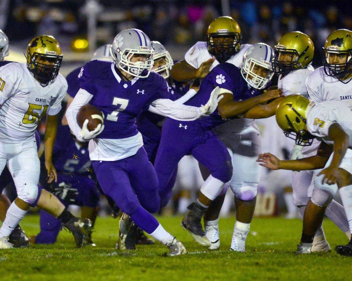 Denair running back Dylan De Silva (7) stiff arms a defender during the CIF Division 7-AA championship game between Denair and Santee at Denair High School in Denair California on December 1, 2018.