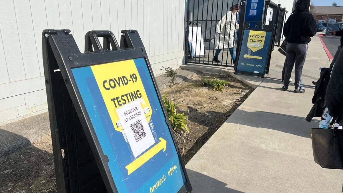 People wait in line for COVID-19 PCR testing in Ceres, Calif. Jan. 12, 2022.