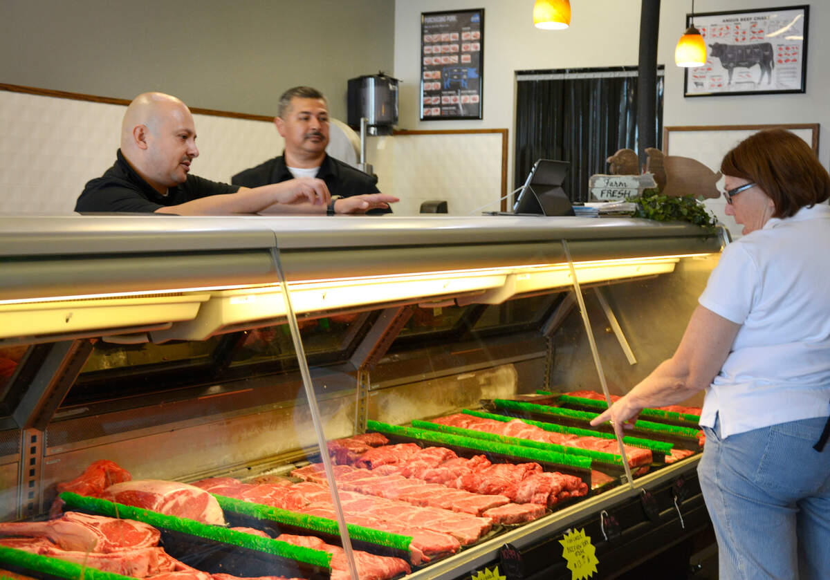 Chuck’s Butcher Shop co-owners Sal Virgen (left) and Carlos Virgen talk with Hughson resident Jana Mitchell.