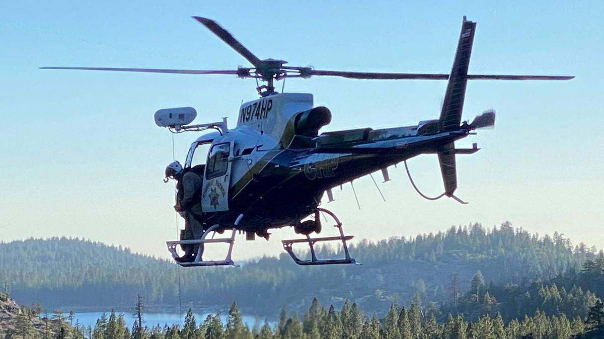 A California Highway Patrol helicopter crew works June 27 on recovering the body of hiker Juan Castaneda, who fell over a waterfall at the popular recreation area Cleo’s Bath in Tuolumne County.