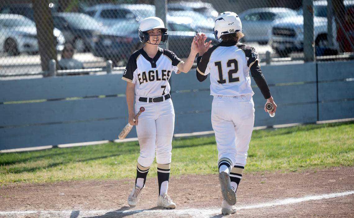 Enochs’ Emma Zulawski (7) greets teammate Lailoni Booker (12) after she scored during 12-0 victory over Modesto in the Central California Athletic League game in Modesto, Calif., Tuesday, April 18, 2023.