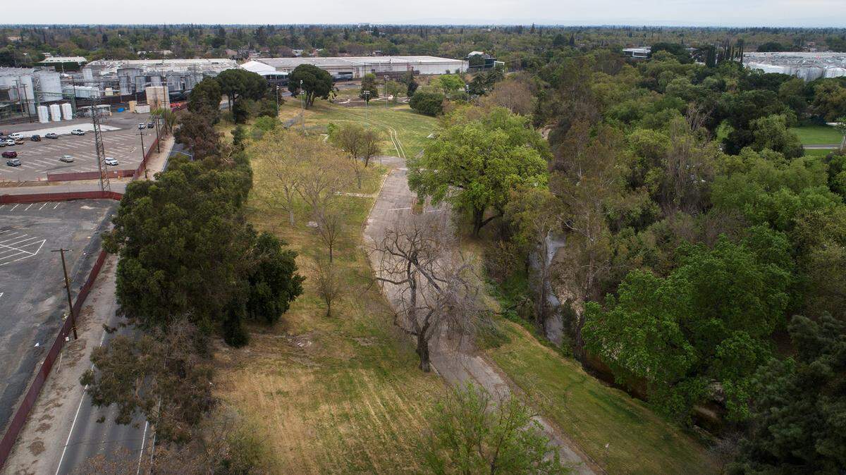 Beard Brook Park with Gallo Winery on the east side of Dry Creek in Modesto, Calif., on Thursday, March 17, 2022. The city of Modesto is working on a land swap with Gallo Winery. The city would trade the 12-acre Beard Brook Park for a 12-acre, half-mile strip of open land Gallo owns along the Tuolumne River between Dry Creek and Santa Cruz Avenue.