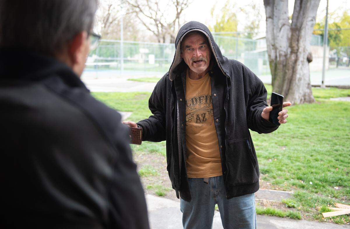 Homeless resident Kevin Walker talks with Modesto councilmember Nick Bavaro at Graceada Park in Modesto, Calif., Wednesday, March 29, 2023.