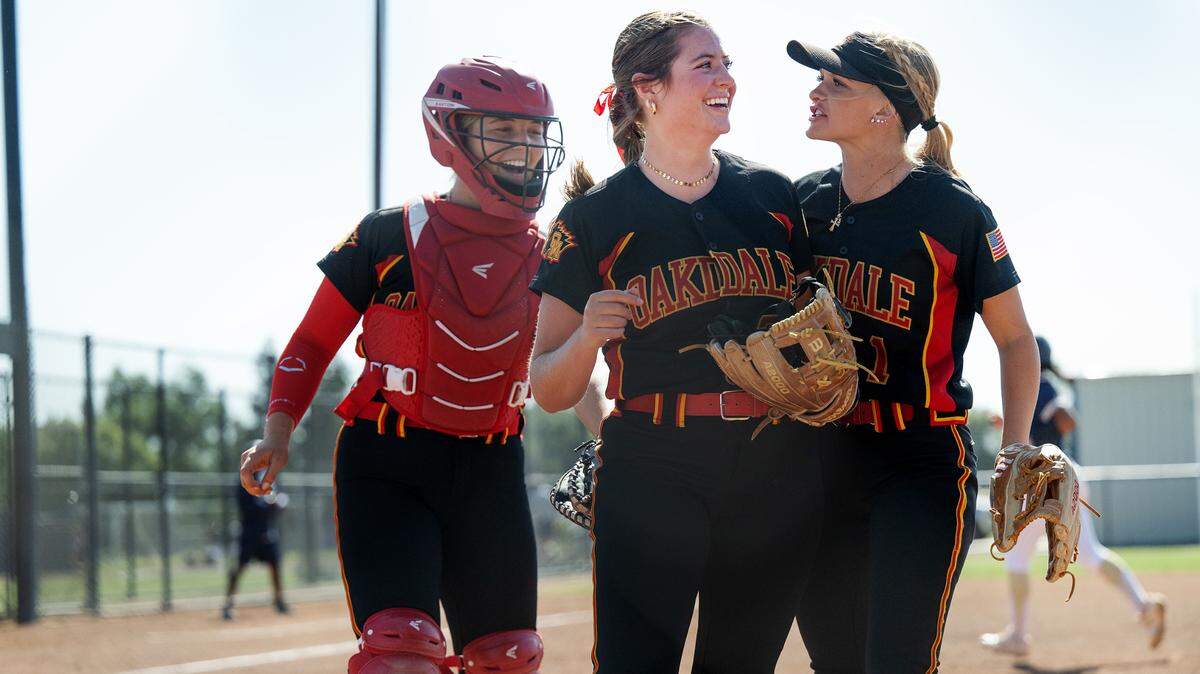 Oakdale players Raegen Everett, middle, Jayci Volonte, right, and Presley Barnes, left, walk off the field after closing out the side of Central Catholic hitters during the Valley Oak League game at Central Catholic High School in Modesto, Calif., Tuesday, May 8, 2024. Everett struck out seven batters in seven innings in the 6-3 Oakdale win.