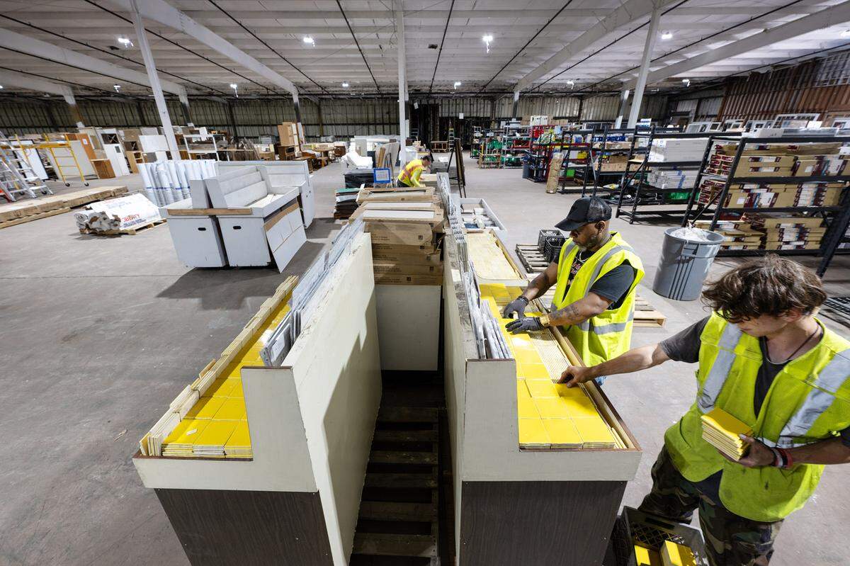 Volunteers Joseph Perkins, right, and Curtis Crawford, left, sort tile at the new Habitat for Humanity Restore location on Tenaya Drive in Modesto, Calif., Thursday, June 22, 2023.