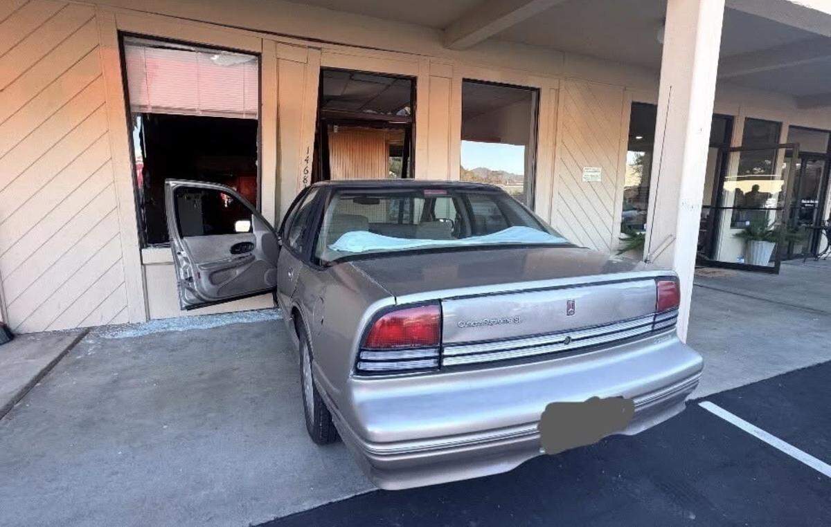 A vehicle is shown after crashing into a commercial building on Mono Way in Sonora on Feb. 4, 2026. Authorities said the driver mistakenly pressed the accelerator while parking.