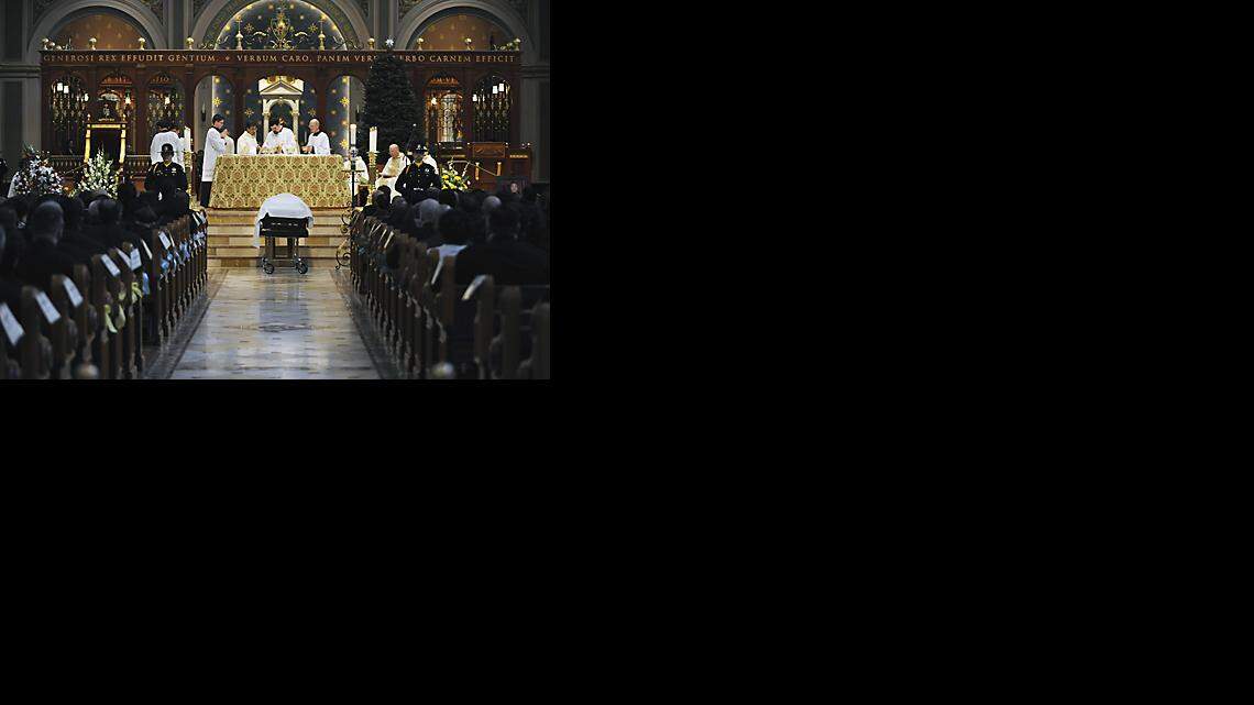 The body of Deputy Sheriff Vu. D. Nguyen rests in front of the alter at the Cathedral of the Blessed Sacrament during Thursday mornings funeral service in Downtown Sacramento.