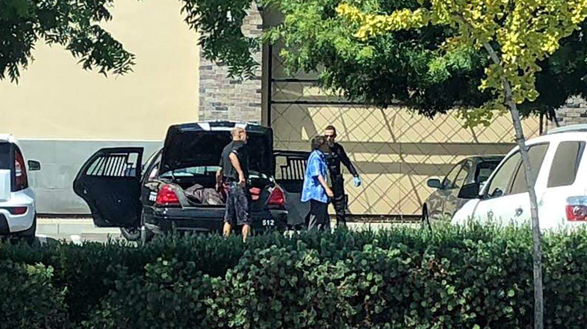 A passerby took this photograph Wednesday of an Escalon police officer dropping off two homeless people in the Rite Aid parking lot at Briggmore and McHenry avenues in Modesto, sparking criticism from Modesto’s police chief.