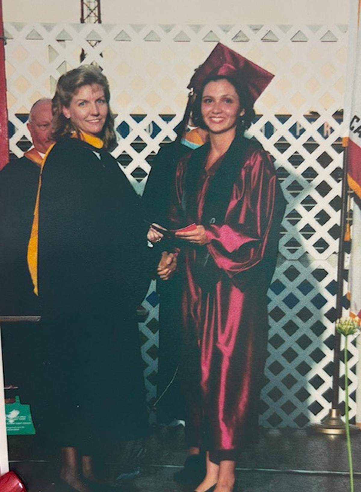 In this 2001 photo, brand-new Modesto High School graduate Vanessa Buitrago shakes with Cindy Marks, who then and now is a Board of Education trustee.
