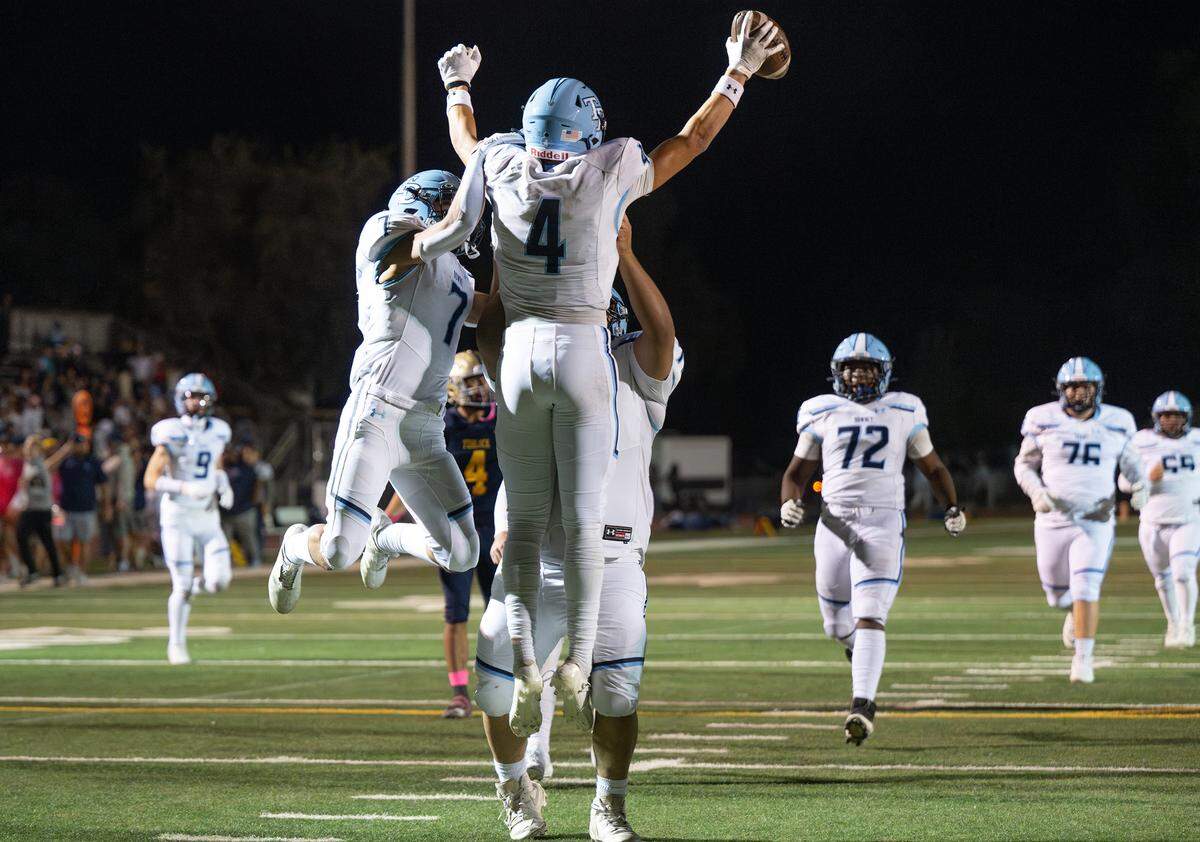 Downey’s Joseph Ramirez celebrates a touchdown with teammates during the Central California Athletic League game with Turlock at Turlock High School in Turlock, Friday, Oct. 18, 2024.
