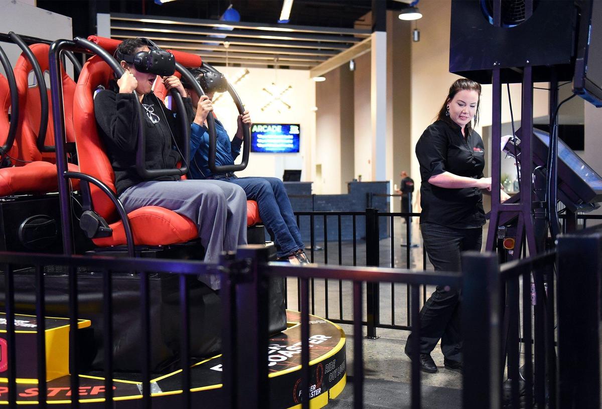 Manager of gaming Melissa McKiernan (right) operates the virtual roller coaster at Ten Pin Fun Center in Turlock, Calif. on Tuesday May 14, 2019. Also pictured are Parris Ayres (left) and Stephanie Valgos riding the coaster.