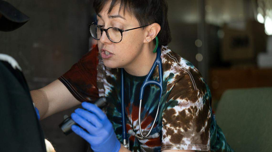 Valley Streetz Harm Reduction physician Dr. Andie Silva cares for a client with an open wound in Modesto, Calif., Friday, April 12, 2024. The program provides harm reduction services and medical treatment at The Rock Church on Friday mornings.