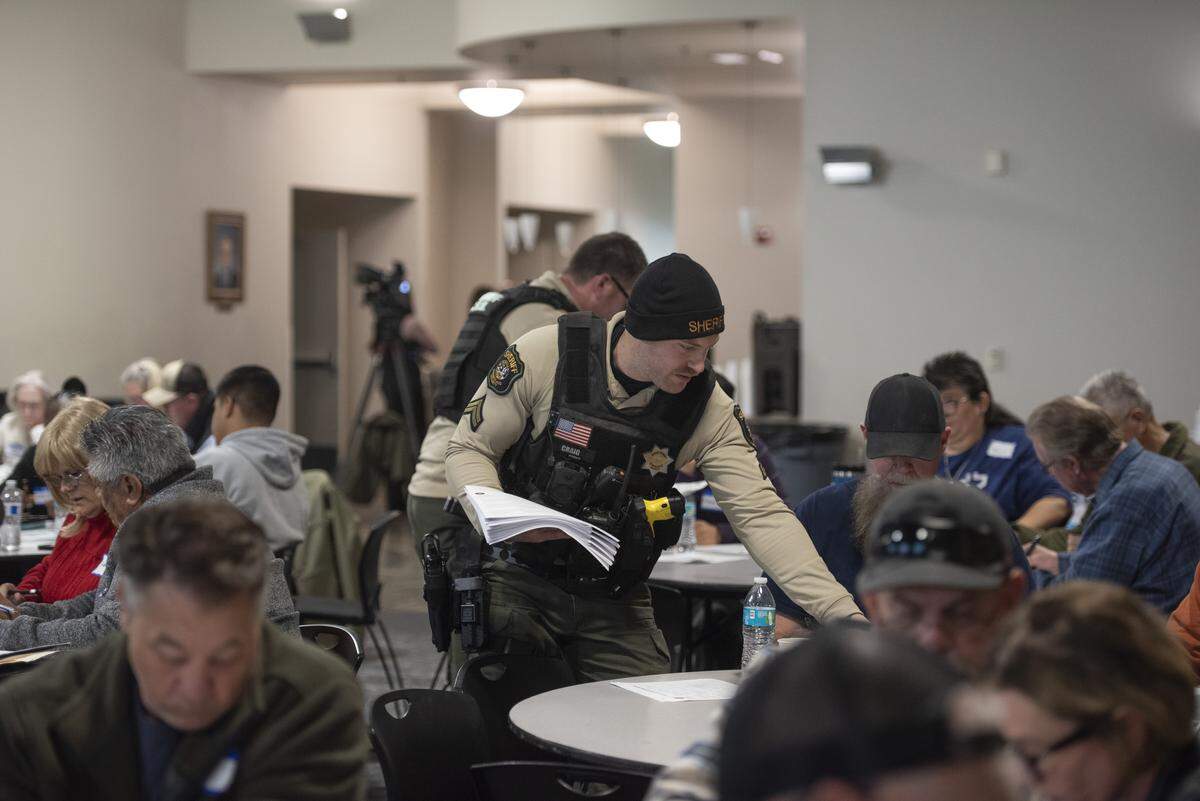 A Stanislaus County Sheriff’s Office deputy hands out materials during a Dec. 15 security workshop in Modesto, attended by hundreds of faith leaders and volunteers. The training focused on emergency preparedness, medical response and safety planning for places of worship.