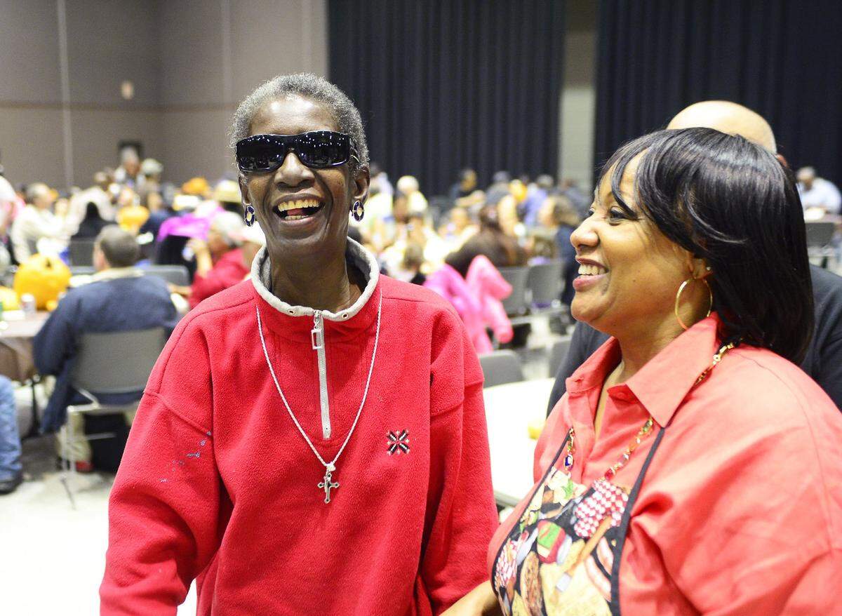 Dellanora Green and Rachell Leviege share a smile and laugh during the annual Thanks-for-Giving meal on Nov. 27, 2014.