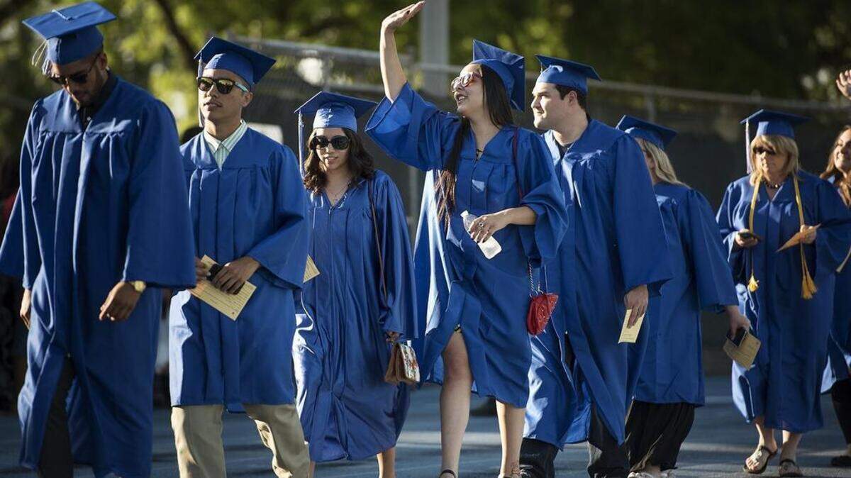 Graduates walk in the processional march during commencement at Modesto Junior College in Modesto, Calif., on Friday, May, 1, 2015.