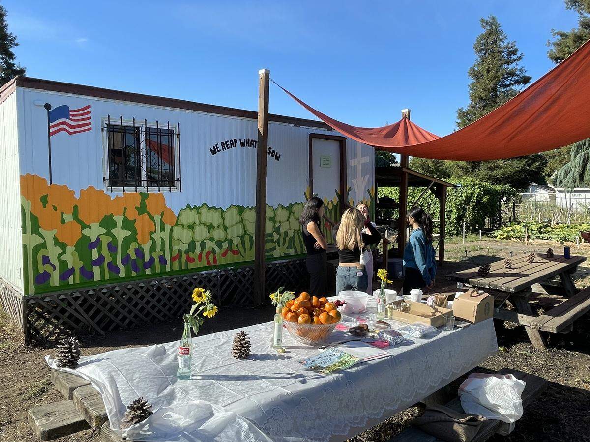 The gathering table in front of the mural at the Church of the Cross Community Garden in Modesto on Saturday, Oct. 4.