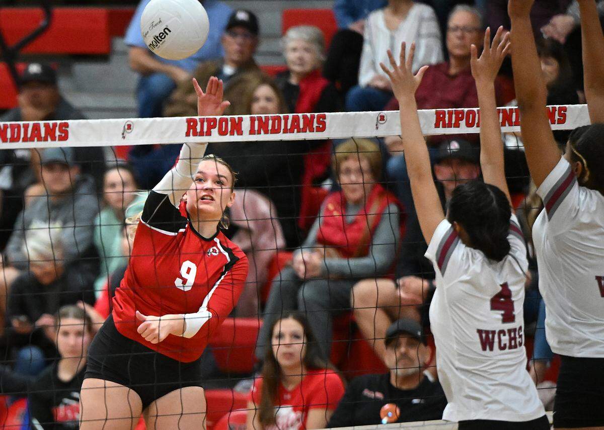 Ripon’s Kylee Fullmer spikes the ball past West Campus players in semifinal playoff match at Ripon High School in Ripon, Calif., Tuesday, Oct. 31, 2023.