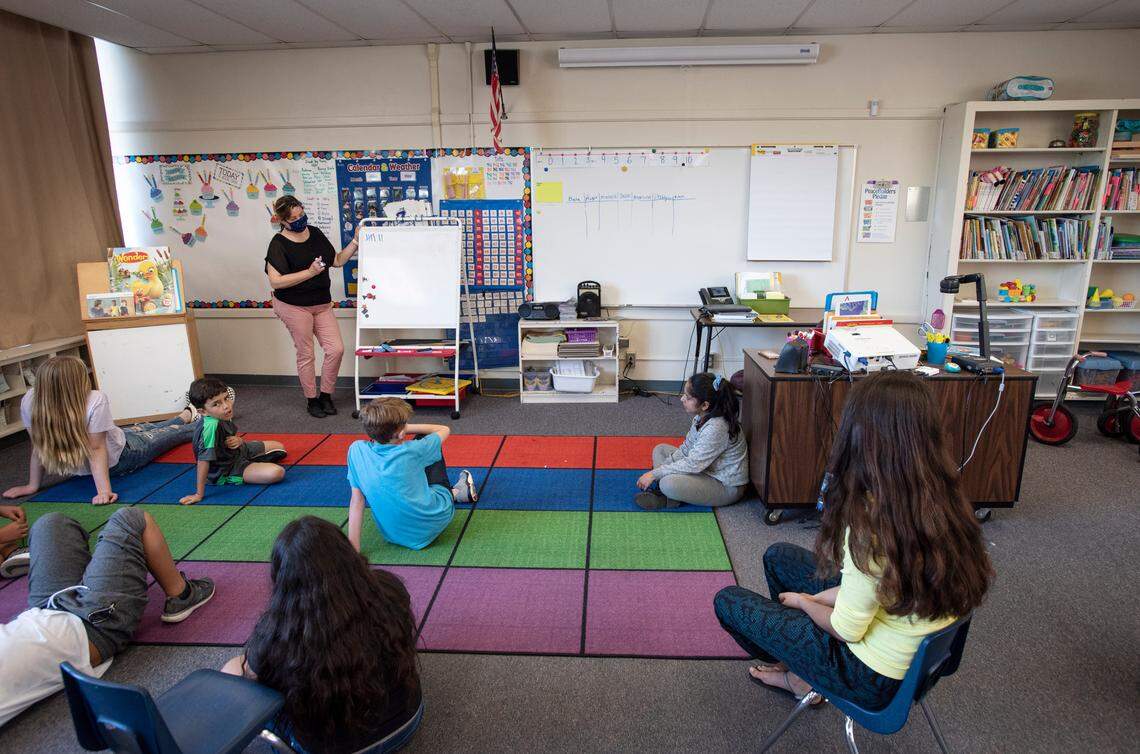 Teacher Evelina Jimenez works with kids during Modesto Schools sponsored child care program at Muir Elementary School in Modesto, Calif., on Tuesday, April 14, 2020. Modesto City Schools has been aiding health care workers, public safety first responders and its own nutrition services employees with free child care at one of its centrally located elementary campuses.