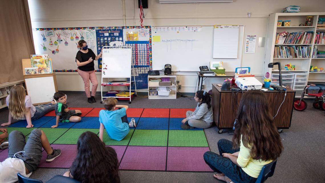 Teacher Evelina Jimenez works with kids during Modesto Schools sponsored child care program at Muir Elementary School in Modesto, Calif., on Wednesday, April 15, 2020. Modesto City Schools has been aiding health care workers, public safety first responders and its own nutrition services employees with free child care at one of its centrally located elementary campuses.