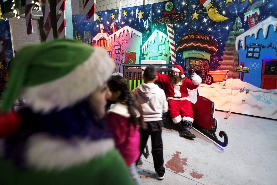 People sit for pictures with Rockin’ Santa at Rockin’ Holidays at Tenth Street Plaza in Modesto, Calif., Saturday, December 3, 2016.