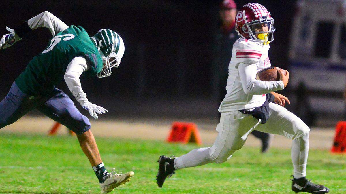 Patterson quarterback Jacob Guevarra (1) runs around the edge during a game between Patterson High School and Central Valley High School at Ceres High School in Ceres California on October 8, 2021.