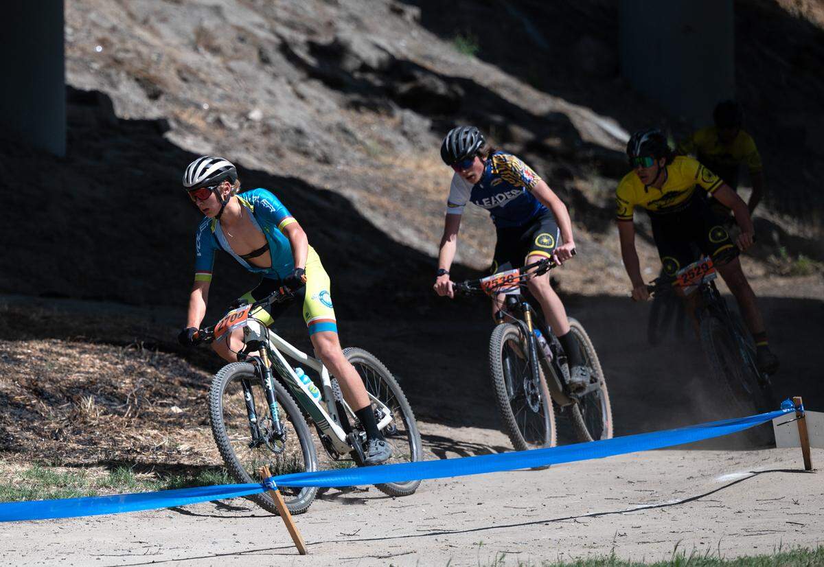 JV division II lead riders Sean Obregon from Santa Cruz, left, Owen Stout, middle and Henry Juarez, both from Monterey, pass under the Highway 99 bridge in Tuolumne River Regional Park during the NorCal Interscholastic Cycling League event in Modesto, Calif., on Saturday, April 9, 2022. Obregon won the 15-mile race with a time of 54:00.08, Strout placed second at 54:25.98 and Jaurez third at 54:44.00.