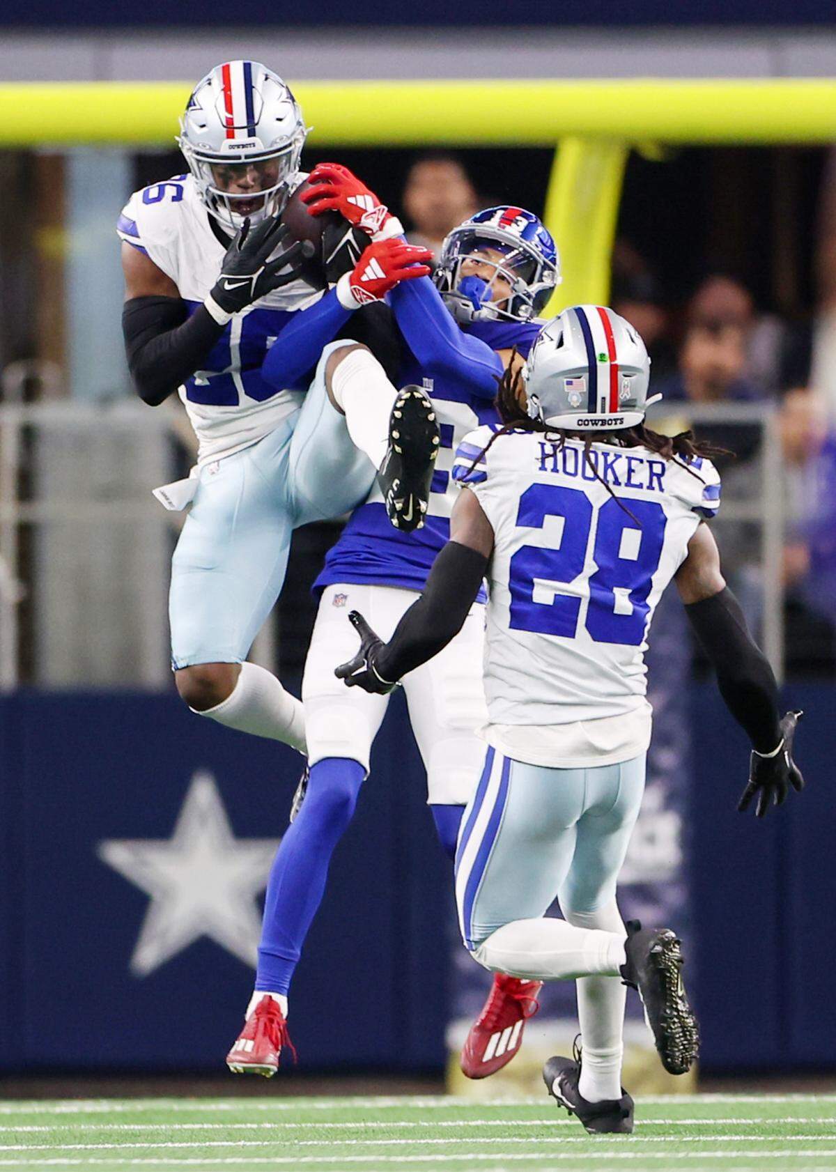 Dallas Cowboys cornerback DaRon Bland (26) intercepts a ball intended for New York Giants wide receiver Jalin Hyatt (13) during the second half at AT&T Stadium in Arlington, Texas, Nov 12, 2023.