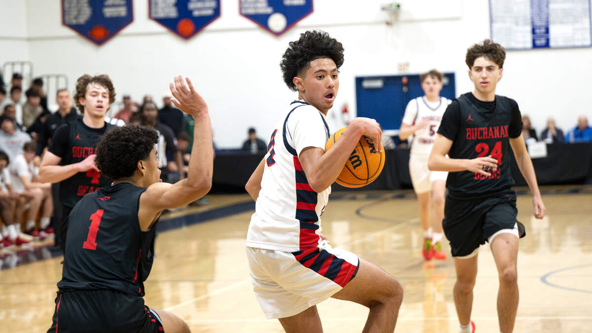 Modesto Christian’s Myles Jones spins around Buchanan defender Desmon Patton on a drive to the basket during the Holiday Hoop Classic championship game at Modesto Christian High School in Salida, Monday, Dec. 30, 2024. Modesto Christian won the game 65-54.