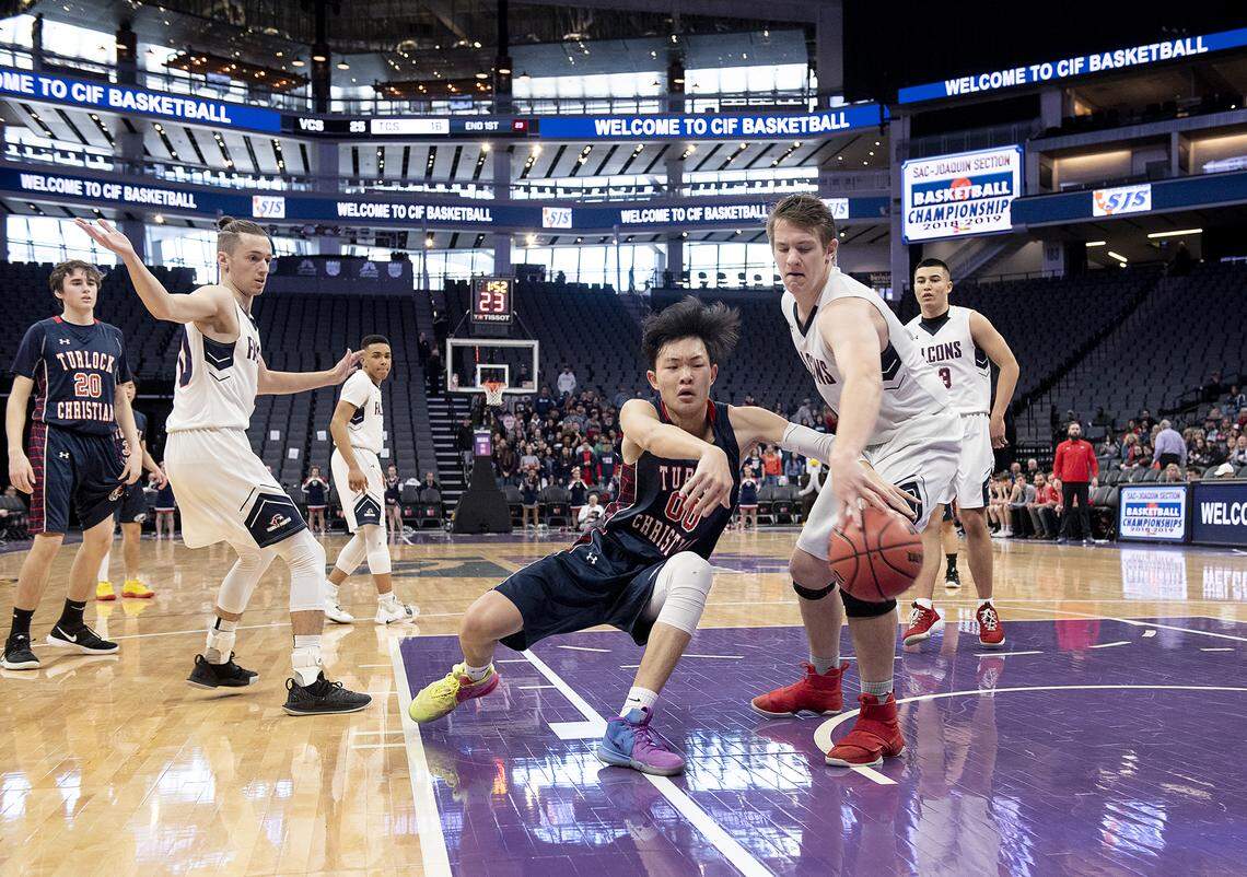 Turlock Christian’s Will Lu has ball knocked loose by Vacaville Christian’s Quinlan Sweany during the Sac-Joaquin Section Division VI boys basketball championship game at the Golden1 Center in Sacramento, Calif., Friday, Feb. 22, 2019.